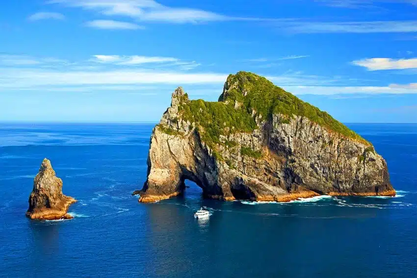 Boat approaching the famous Hole in the Rock, Bay of Islands - NZ North Island Itinerary