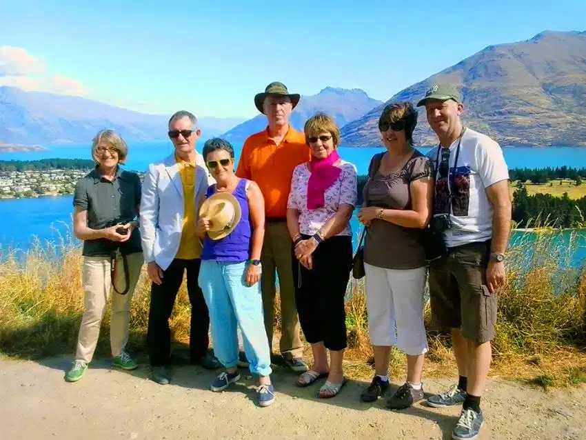 Photo with friends in Queenstown, lake and mountain scenery - NZ South Island Itinerary