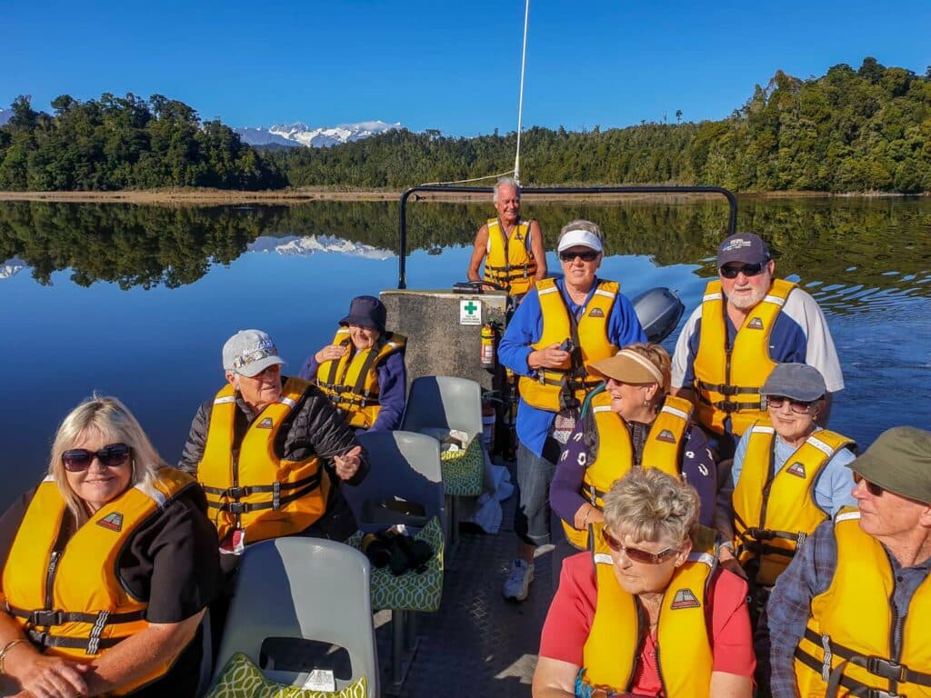 Senior travellers on a wildlife cruise on Okarito Lagoon, New Zealand
