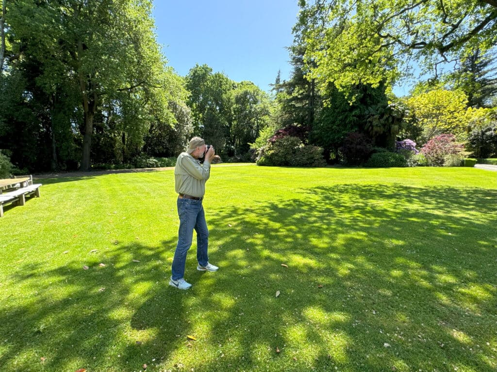 Visitor to Akaunui Homestead taking a photo of the spring gardens