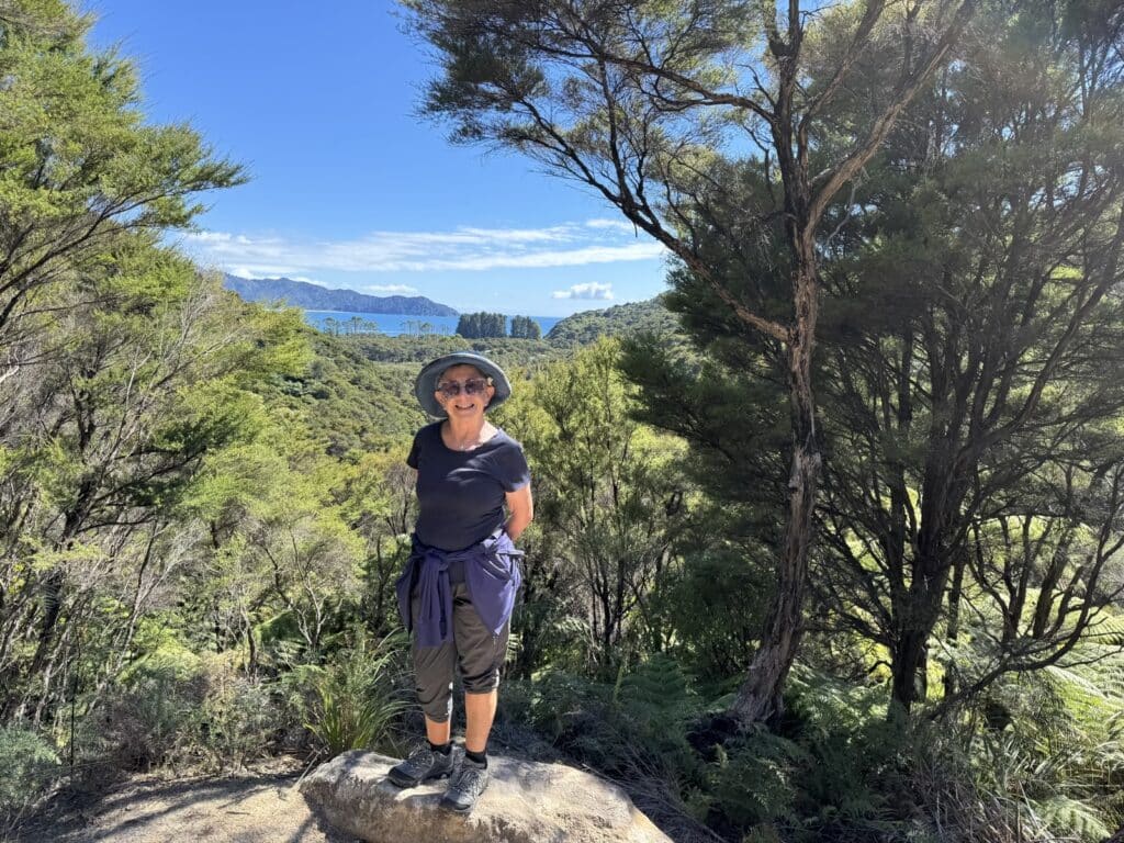 A traveller at the ocean viewpoint on the Abel Tasman Track, New Zealand