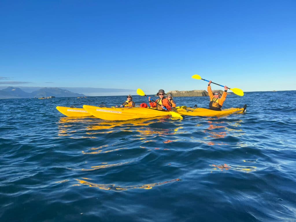 Senior travellers kayaking on the Kaikoura coastline in New Zealand