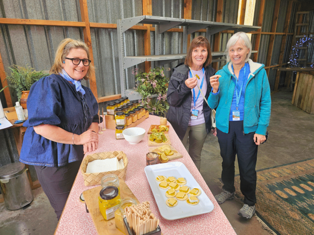 Two female travellers trying Kiwifruit in the Bay of Plenty, New Zealand