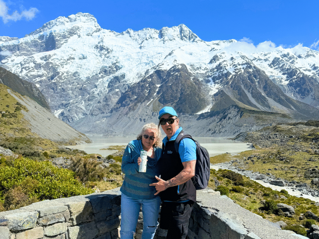 A tour guide and guest at the Lake Mueller lookout in Mt Cook National Park, New Zealand