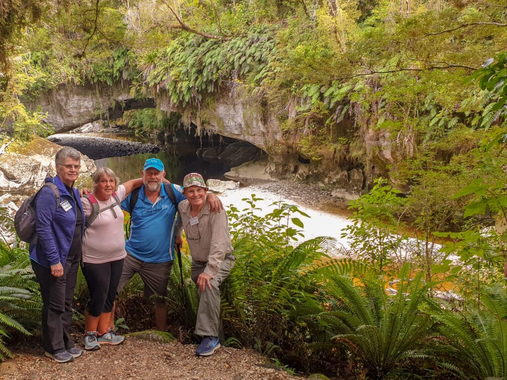 Guide and travellers at Moria Arch in Kahurangi National Park