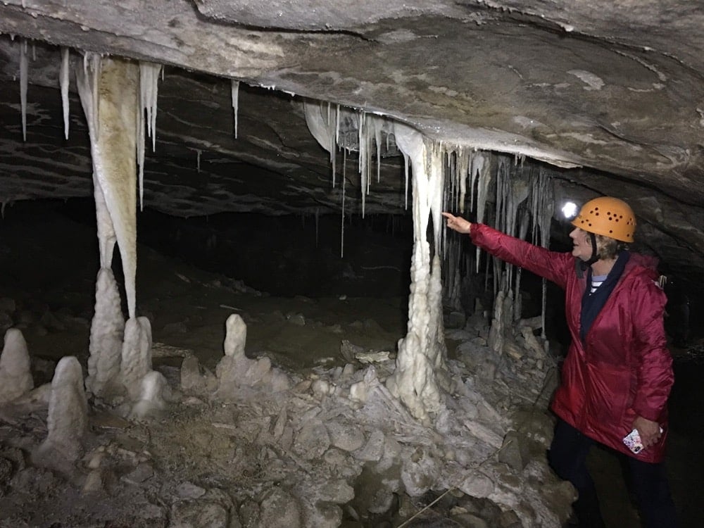 Senior traveller on a guided cave tour at the Nile River, West Coast, New Zealand
