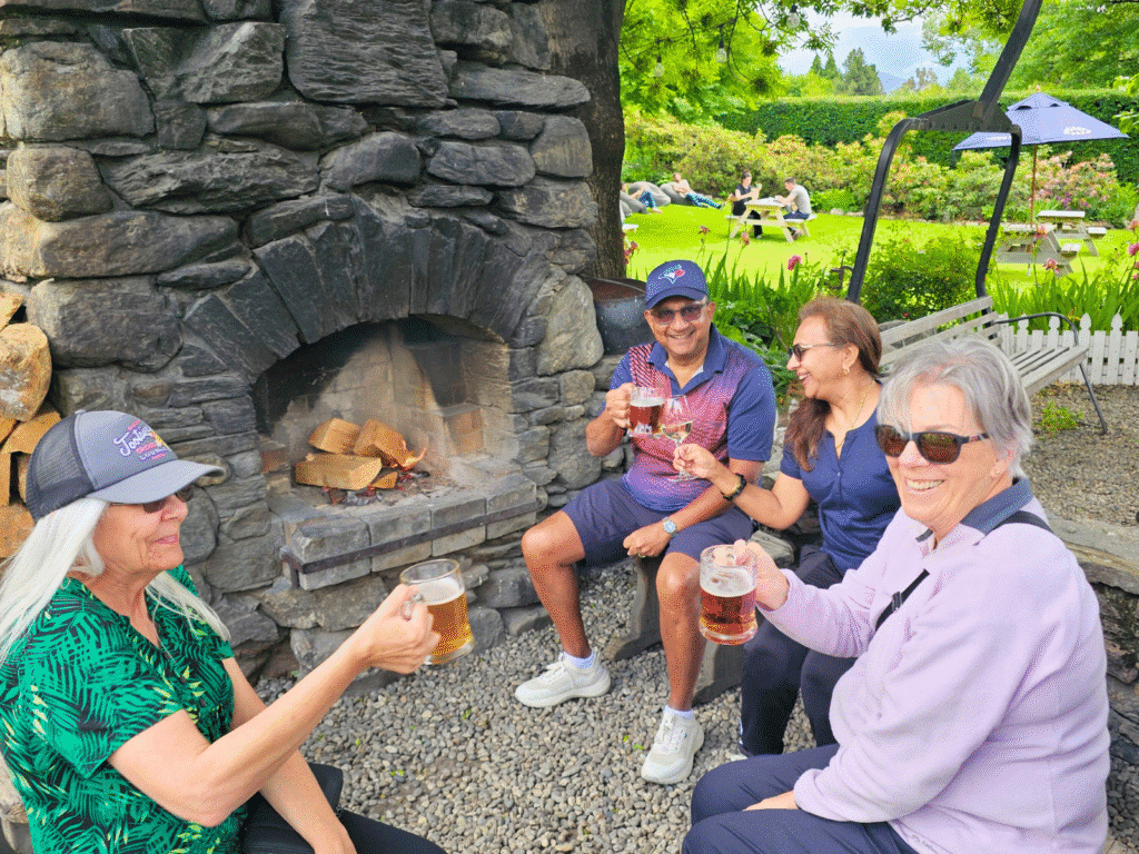 Travellers enjoying a drink in the garden at the Cardrona Hotel in New Zealand