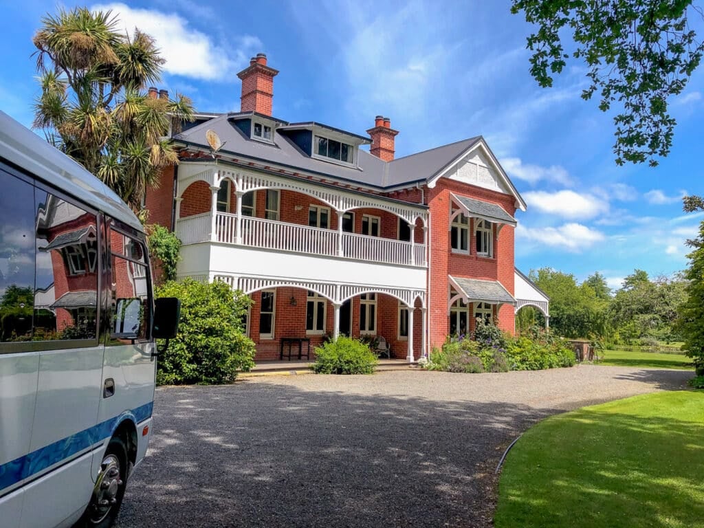 MoaTrek tour coach arriving at historic Akaunui homestead in Canterbury, New Zealand