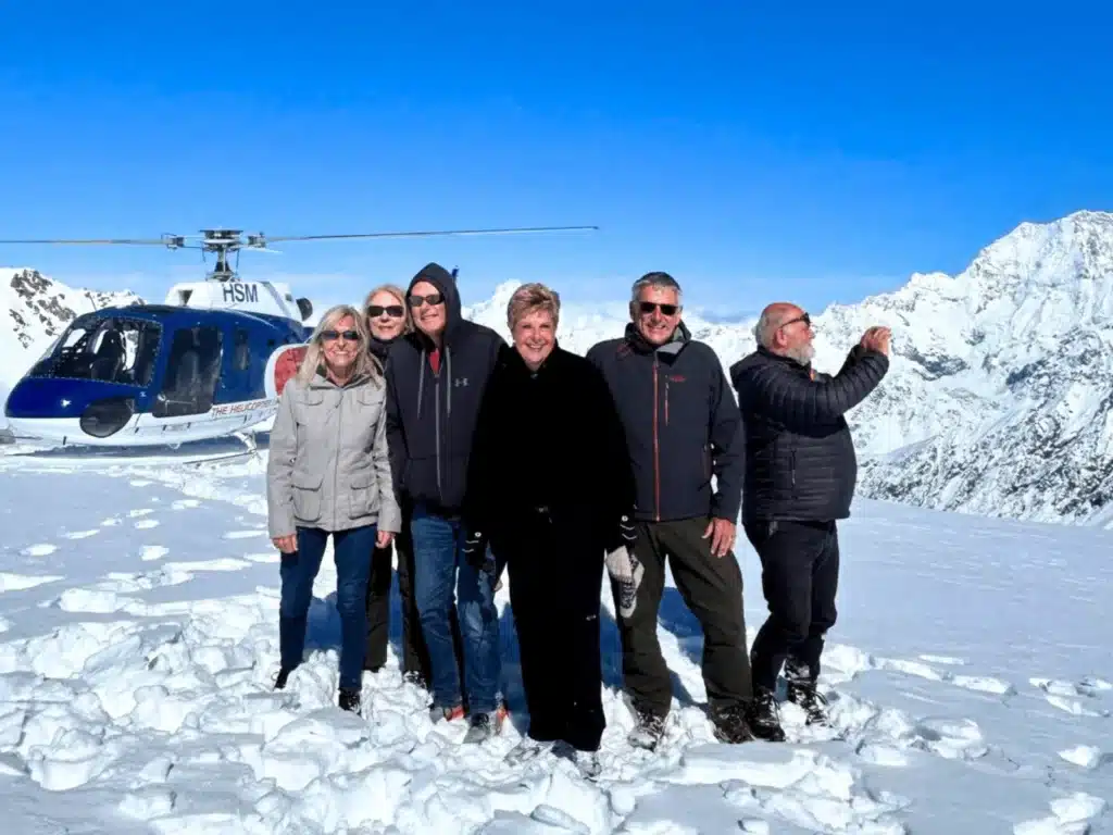 A group of 50+ travellers on a glacier landing on Franz Josef Glacier, South Island, New Zealand