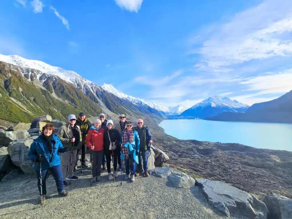 A small group of over 50 travellers at the Tasman Glacier lookout in Mt Cook National Park, New Zealand