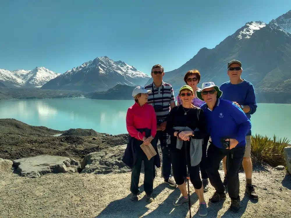 A group of 50+ travellers at the lookout of the Tasman Glacier Lake in Mt Cook National Park, South Island, New Zealand