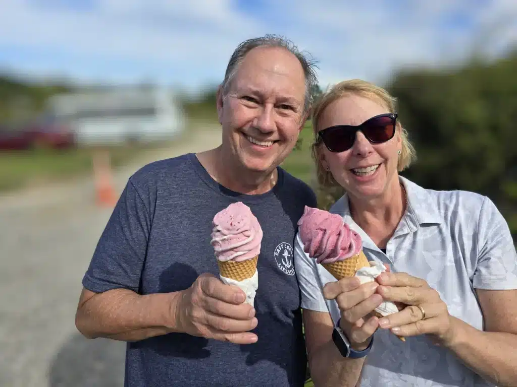 Two over-50 travellers eating ice creams near the beach in New Zealand