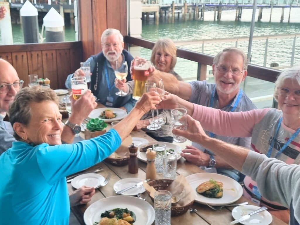 John and Jenny dining with their tour group in Paihia